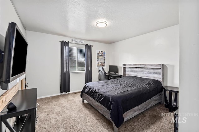 carpeted bedroom with a textured ceiling