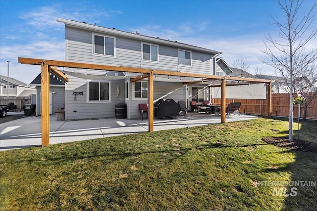 rear view of house with a yard and a patio