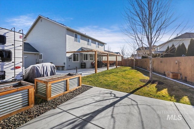 rear view of property featuring a patio area and a yard