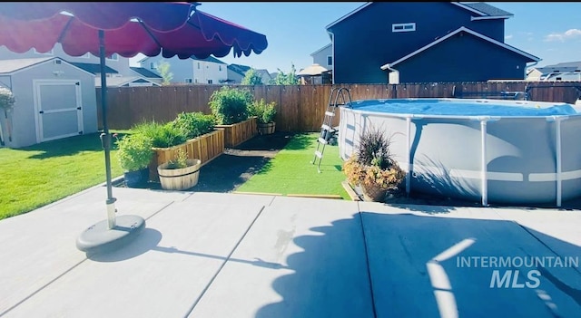 view of patio with a fenced in pool and a shed