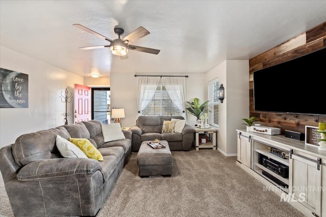 living room with ceiling fan and light colored carpet