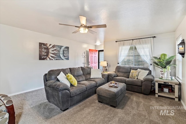 living room featuring ceiling fan and carpet