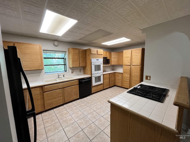 909 E 6th, Moscow, ID 83843 - kitchen featuring black appliances, a sink, tile countertops, and light tile patterned floors