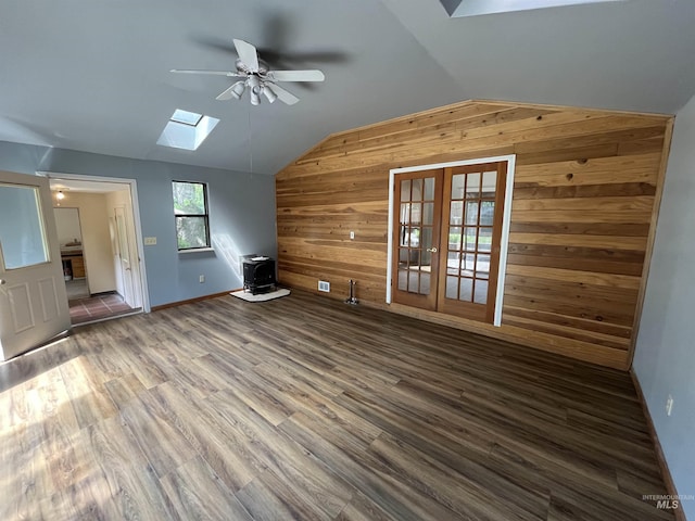 909 E 6th, Moscow, ID 83843 - additional living space featuring wooden walls, a skylight, lofted ceiling, ceiling fan, and a wood stove