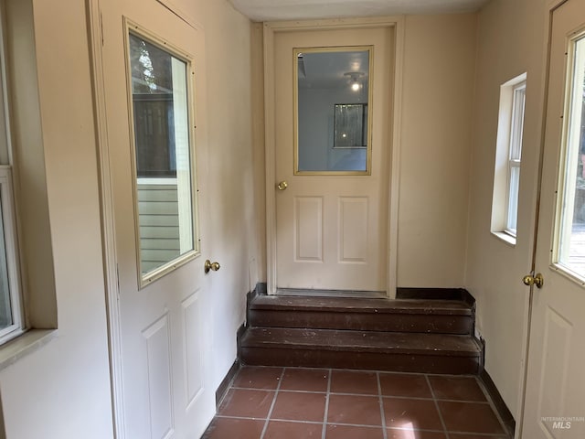 909 E 6th, Moscow, ID 83843 - entryway featuring stairway, dark tile patterned flooring, baseboards, and healthy amount of natural light