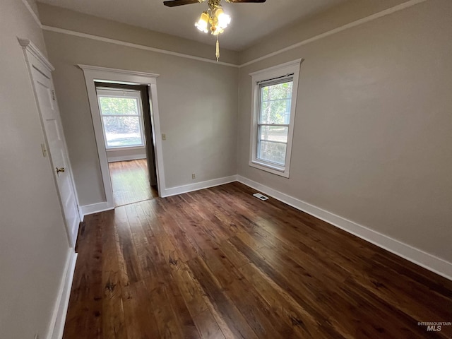 909 E 6th, Moscow, ID 83843 - unfurnished room featuring dark wood-type flooring, healthy amount of natural light, ceiling fan, and baseboards