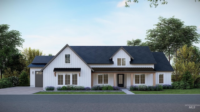 modern farmhouse style home with roof with shingles, board and batten siding, and driveway