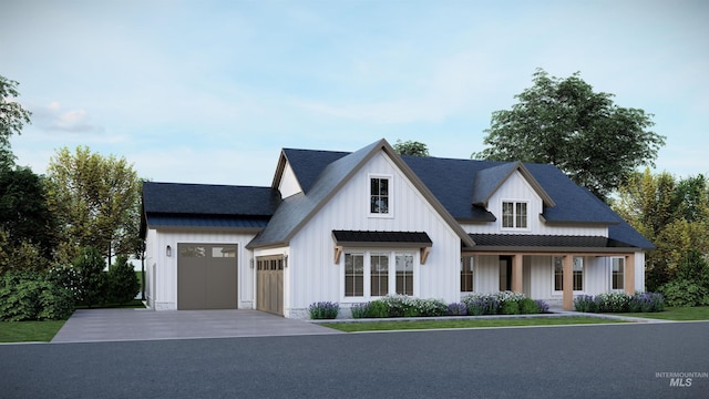 modern farmhouse style home with board and batten siding, metal roof, driveway, an attached garage, and a standing seam roof