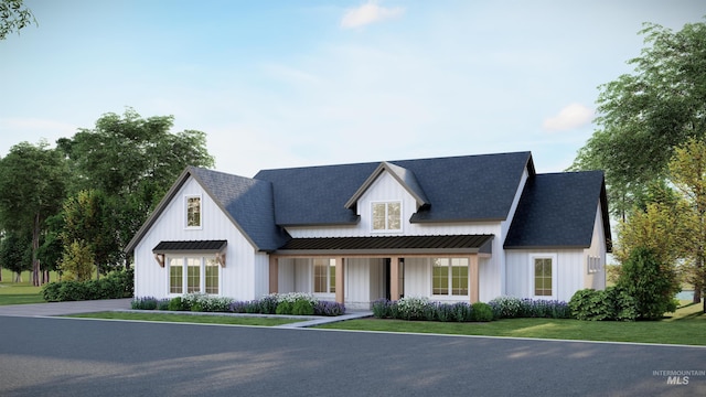 modern farmhouse style home with a front yard, board and batten siding, and roof with shingles