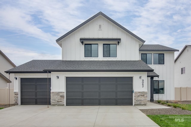 modern farmhouse with board and batten siding, driveway, and a shingled roof