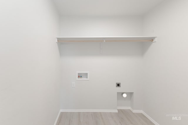 11179 Cart St, Caldwell, ID 83605 - washroom featuring electric dryer hookup, light wood-type flooring, baseboards, hookup for a washing machine, and laundry area