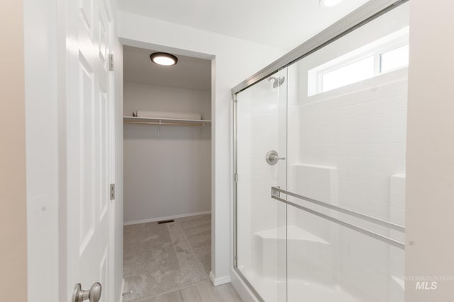 11179 Cart St, Caldwell, ID 83605 - full bath featuring a walk in closet, baseboards, visible vents, and a shower stall