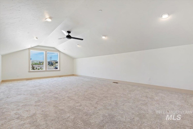 bonus room with baseboards, a ceiling fan, carpet, and lofted ceiling