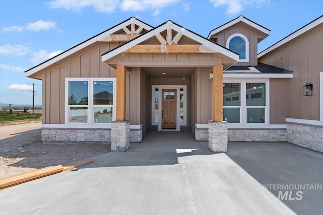view of front of property with board and batten siding and stone siding