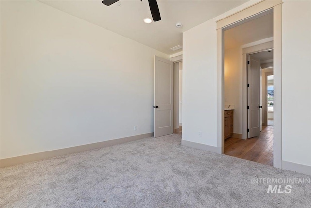 unfurnished bedroom featuring a ceiling fan, baseboards, visible vents, and carpet