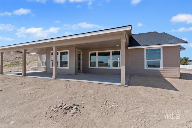 back of property with a patio