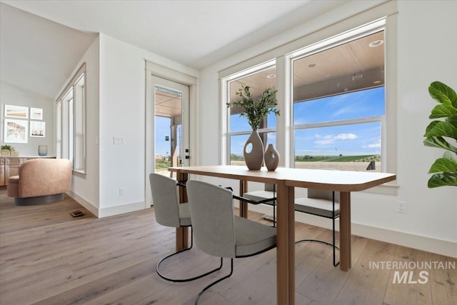 dining room with light wood-style floors, baseboards, and visible vents