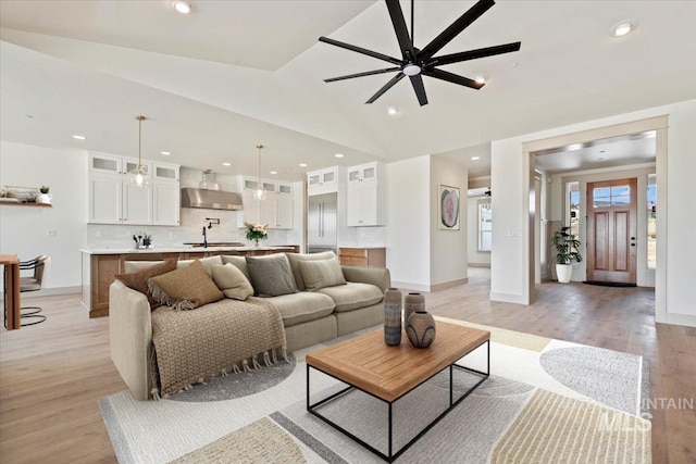 living area with recessed lighting, ceiling fan, baseboards, and light wood-style floors