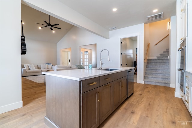 kitchen with light wood-type flooring, visible vents, appliances with stainless steel finishes, and a sink