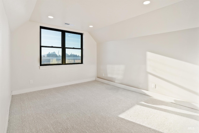additional living space with visible vents, baseboards, vaulted ceiling, carpet flooring, and recessed lighting