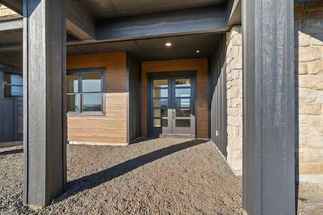property entrance featuring french doors and stone siding