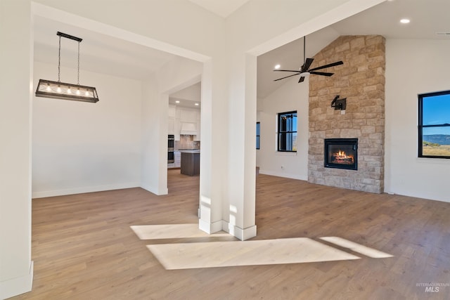 interior space with a stone fireplace, visible vents, a wooden deck, and ceiling fan