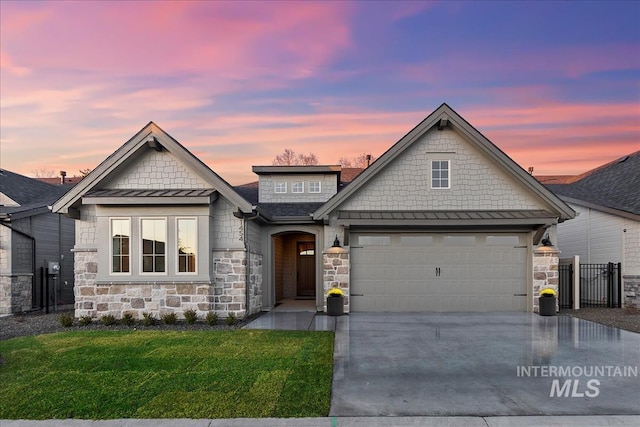 craftsman inspired home featuring a garage and a yard