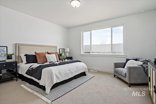 carpeted bedroom with baseboards and visible vents