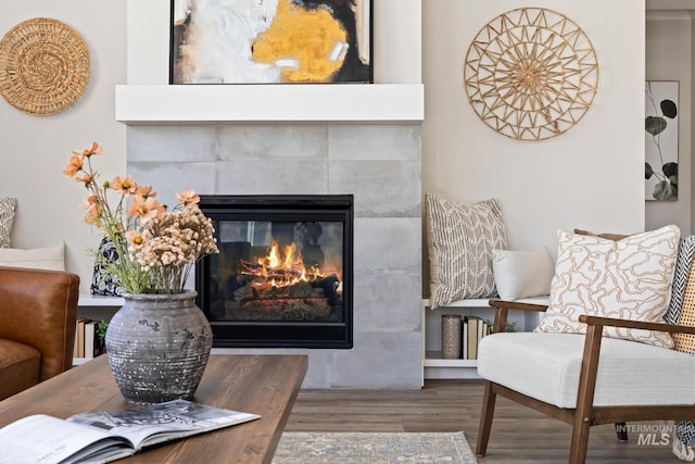 sitting room featuring wood finished floors and a tile fireplace