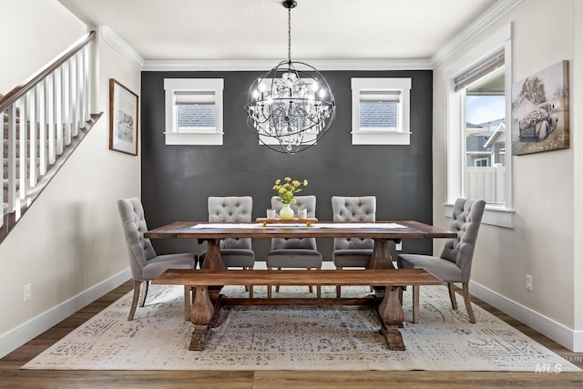 dining area featuring stairs, baseboards, an inviting chandelier, and wood finished floors