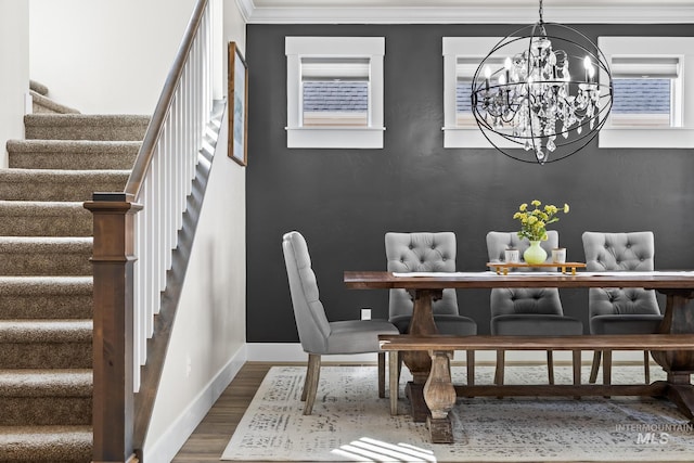 dining area with crown molding, stairs, wood finished floors, baseboards, and a chandelier