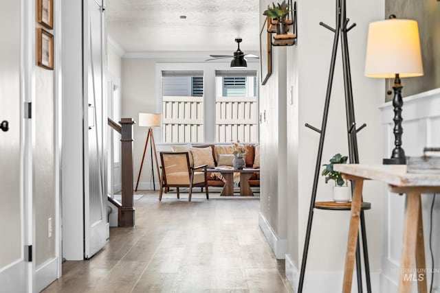 hall with baseboards and ornamental molding