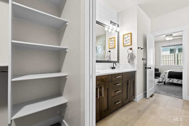 ensuite bathroom with double vanity, ceiling fan, walk in shower, connected bathroom, and tile patterned floors