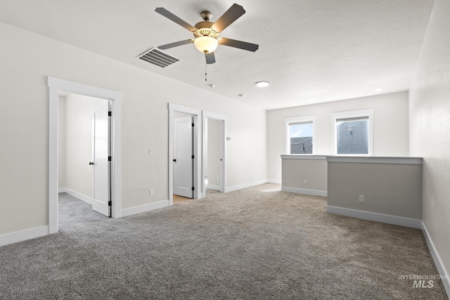interior space featuring ceiling fan, visible vents, and baseboards