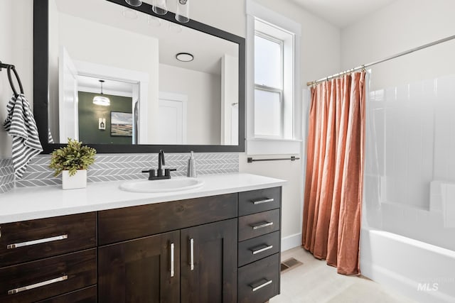 bathroom with vanity, shower / tub combo with curtain, visible vents, and tasteful backsplash