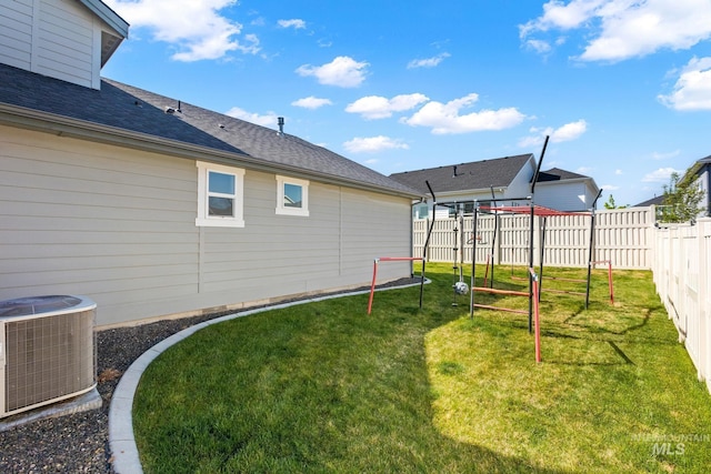 view of yard with fence and cooling unit
