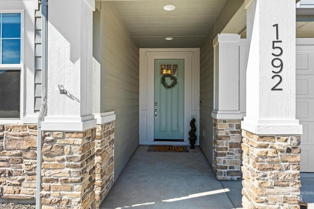 property entrance featuring a porch and stone siding
