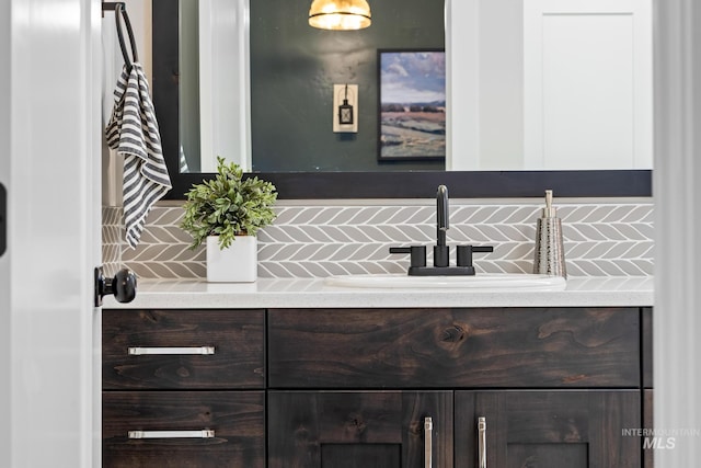 bathroom with vanity and tasteful backsplash