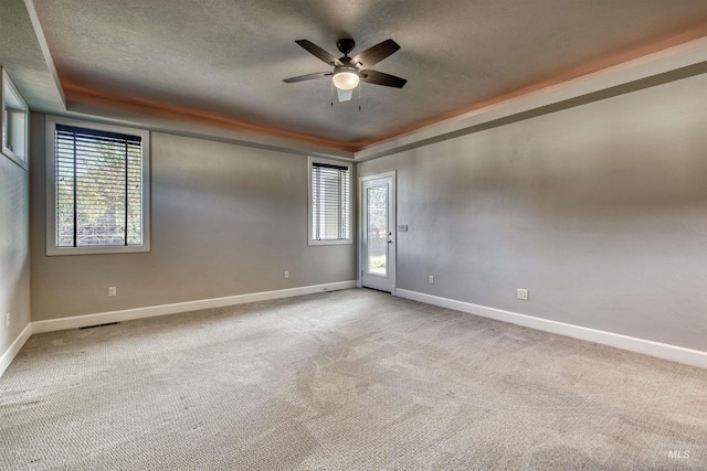 unfurnished room featuring carpet flooring, ceiling fan, and a textured ceiling