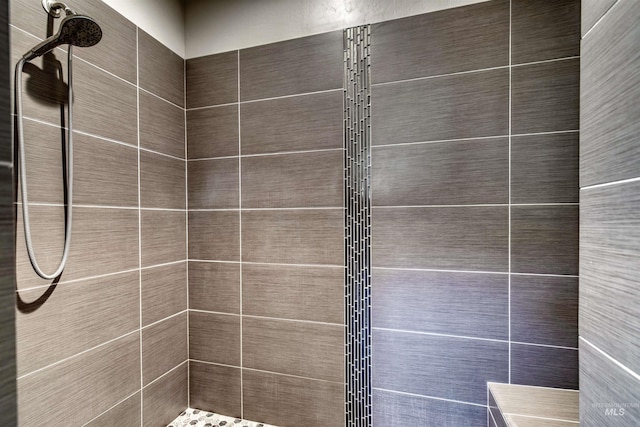 bathroom with tiled shower