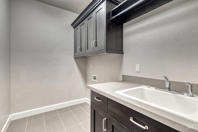 clothes washing area featuring cabinets, washer hookup, and sink