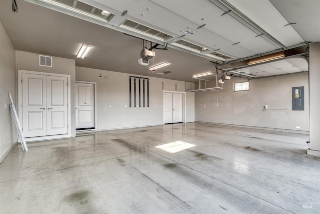 garage with electric panel and a garage door opener