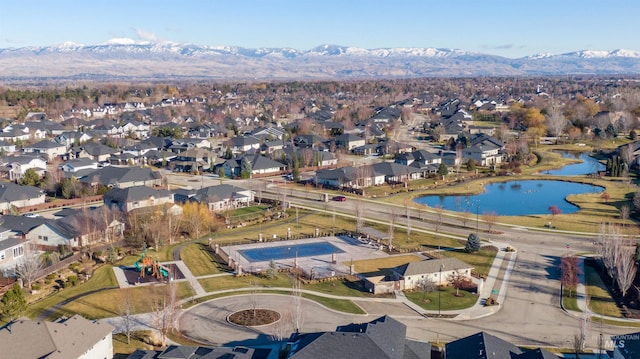 drone / aerial view with a water and mountain view