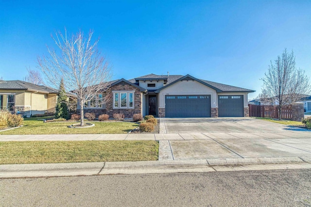 view of front of property featuring a garage and a front lawn