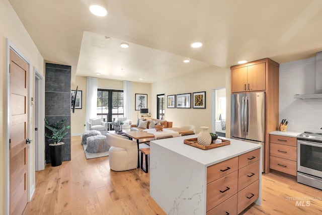 kitchen featuring light countertops, appliances with stainless steel finishes, light wood-style flooring, and recessed lighting