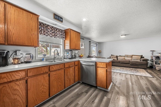 408 Tanoak Cir, Nampa, ID 83686 - kitchen with a peninsula, dishwasher, a sink, and a textured ceiling