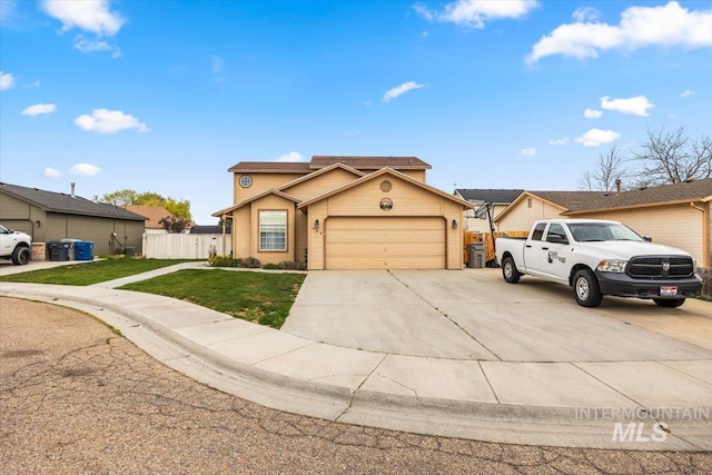 408 Tanoak Cir, Nampa, ID 83686 - view of front of house featuring concrete driveway, an attached garage, fence, and a front yard