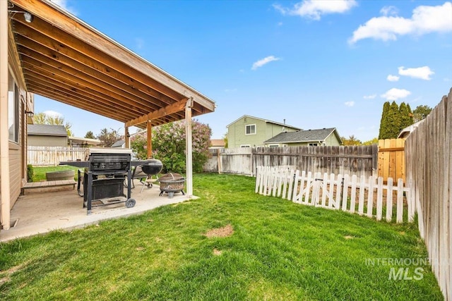 408 Tanoak Cir, Nampa, ID 83686 - view of yard featuring a patio area, a fenced backyard, and an outdoor fire pit