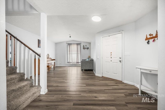 408 Tanoak Cir, Nampa, ID 83686 - entrance foyer featuring wood finished floors, lofted ceiling, and stairway