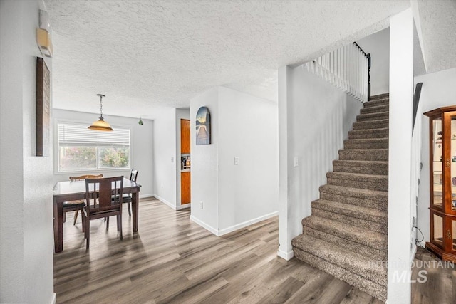 408 Tanoak Cir, Nampa, ID 83686 - stairway featuring wood finished floors, a textured ceiling, and baseboards